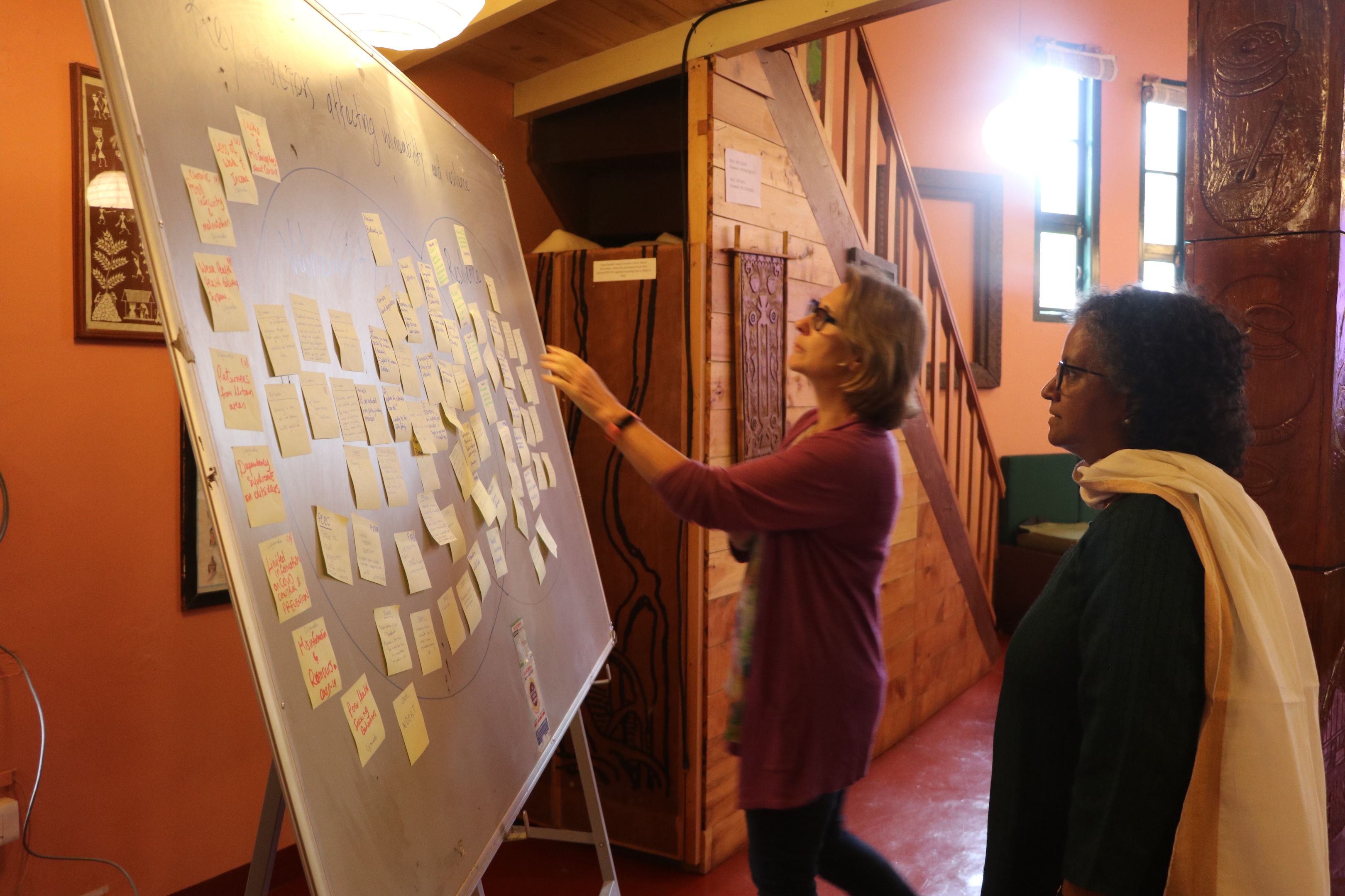 A couple of woman planning on a board